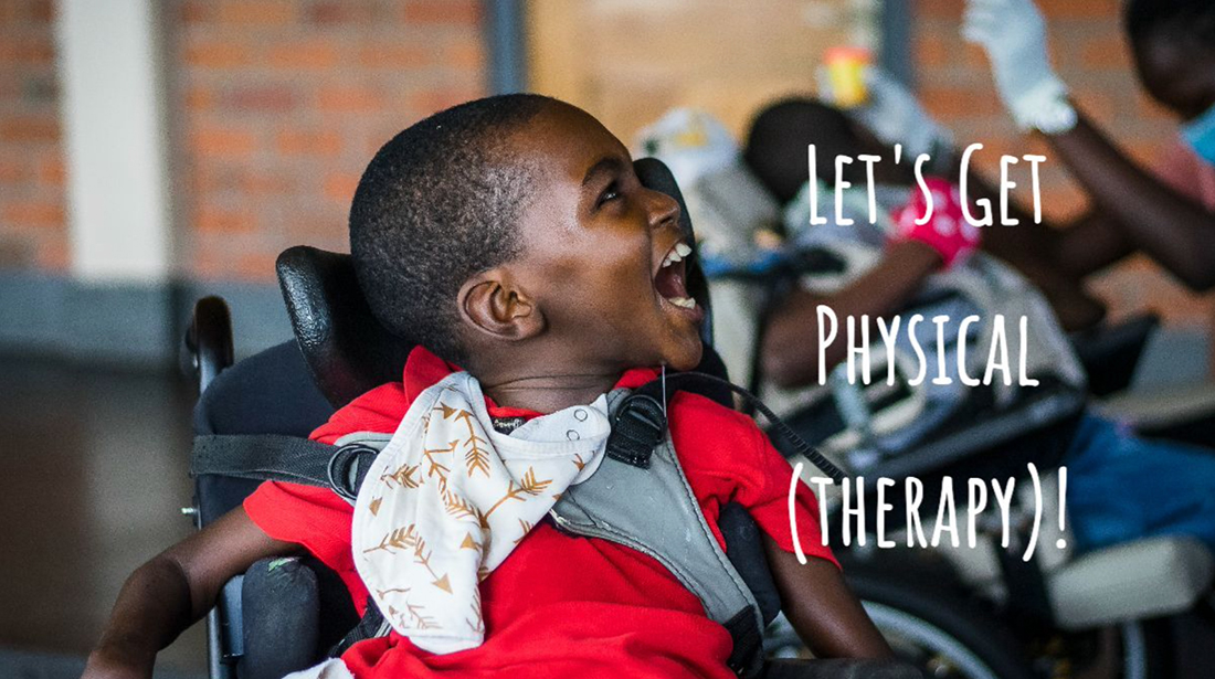 A young boy smiling during a physical therapy session